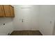 Laundry room featuring oak cabinets and a white door leading to the exterior at 12505 W Adams St, Avondale, AZ 85323