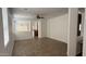 Open-concept living area with wood-look tile flooring, neutral walls, and a ceiling fan at 12505 W Adams St, Avondale, AZ 85323