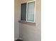 An exterior view of window showing sun screen and stone texture at 12505 W Adams St, Avondale, AZ 85323