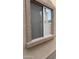 Close-up showcasing the window's frame and textured exterior of the home at 12505 W Adams St, Avondale, AZ 85323