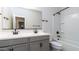 Modern bathroom features a double sink vanity, a combination tub and shower, and sleek black fixtures at 12547 W Stella Ln, Litchfield Park, AZ 85340