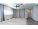 Bright bedroom with large window, modern ceiling fan, and neutral carpeting at 12547 W Stella Ln, Litchfield Park, AZ 85340