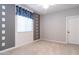 Neutral bedroom featuring a window with stylish valance, gray accent wall, carpet, and ceiling fan at 12547 W Stella Ln, Litchfield Park, AZ 85340