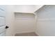 A walk-in closet with white walls, carpet flooring, and a metal hanging rod at 12547 W Stella Ln, Litchfield Park, AZ 85340