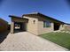 Charming home exterior with low-maintenance landscaping and an extended three-car garage at 12547 W Stella Ln, Litchfield Park, AZ 85340