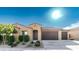 Inviting single-story home featuring a three-car garage, neutral color scheme, desert landscaping, and covered entryway at 12547 W Stella Ln, Litchfield Park, AZ 85340