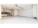 Spacious three-car garage with epoxy flooring and custom car decal, perfect for car enthusiasts at 12547 W Stella Ln, Litchfield Park, AZ 85340