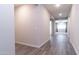 Hallway featuring wood-look flooring with views of living spaces, hallways, and neutral paint at 12547 W Stella Ln, Litchfield Park, AZ 85340