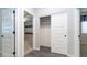 Bright hallway with a closet and doors leading to the bedrooms, all showcasing wood-look tile flooring at 12547 W Stella Ln, Litchfield Park, AZ 85340