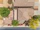 Aerial view of a beautifully landscaped backyard featuring mature trees and colorful landscaping at 12630 W Corrine Dr, El Mirage, AZ 85335