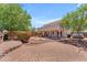 Expansive backyard featuring a brick patio, seating area, mature trees, and outdoor grill, perfect for entertaining at 12630 W Corrine Dr, El Mirage, AZ 85335