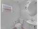 Simple, yet elegant half bathroom, with a pedestal sink and modern lighting at 12630 W Corrine Dr, El Mirage, AZ 85335
