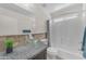 Bathroom featuring a glass sink bowl, granite countertop, and a full shower/tub at 12630 W Corrine Dr, El Mirage, AZ 85335