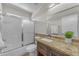Bathroom with a vanity, modern sink, granite countertops, and glass-door shower at 12630 W Corrine Dr, El Mirage, AZ 85335