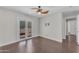 Bright bedroom with hardwood floors, ceiling fan, and sliding glass door to balcony at 12630 W Corrine Dr, El Mirage, AZ 85335