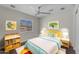 Cozy bedroom with playful decor, a window, and a ceiling fan at 12630 W Corrine Dr, El Mirage, AZ 85335