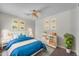 Bright bedroom with a ceiling fan, a white bed and a decorative rug at 12630 W Corrine Dr, El Mirage, AZ 85335