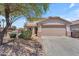 Front exterior showcasing a two-car garage, desert landscaping, and a home with a classic tile roof at 12630 W Corrine Dr, El Mirage, AZ 85335