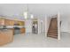 Bright kitchen and stairwell with stainless steel appliances and tile floors at 12630 W Corrine Dr, El Mirage, AZ 85335