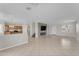Spacious living area connected to the kitchen, featuring tile floors and a contemporary fireplace at 12630 W Corrine Dr, El Mirage, AZ 85335