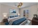 Bedroom with large bed, ceiling fan and sliding glass doors to the outside at 12630 W Corrine Dr, El Mirage, AZ 85335