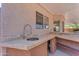 Outdoor sink with granite countertop and decorative faucet at 12630 W Corrine Dr, El Mirage, AZ 85335