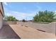 View of an outdoor patio featuring trees and a textured wall at 12630 W Corrine Dr, El Mirage, AZ 85335