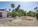 Expansive backyard featuring a putting green, mature trees, and desert landscaping at 12820 N 83Rd Pl, Scottsdale, AZ 85260