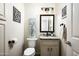 Tastefully designed powder room features decorative mirror, charming decor, and a marble-top vanity at 12820 N 83Rd Pl, Scottsdale, AZ 85260