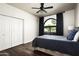 Comfortable bedroom showcasing a large window, closet space, neutral walls, and wood-look floors at 12820 N 83Rd Pl, Scottsdale, AZ 85260
