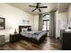 Bedroom with hard wood flooring, natural lighting, dark wood furniture, and ceiling fan at 12820 N 83Rd Pl, Scottsdale, AZ 85260