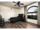 Bedroom features hard wood floors, a ceiling fan, dark wood furniture, and an arched window at 12820 N 83Rd Pl, Scottsdale, AZ 85260