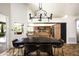 A stylish dining area displays a dark wood table and modern chandelier, next to the kitchen at 12820 N 83Rd Pl, Scottsdale, AZ 85260