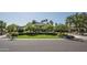 Beautiful single-story home with manicured lawn, mature trees, and a circular driveway with a neutral color scheme at 12820 N 83Rd Pl, Scottsdale, AZ 85260