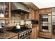 Close-up view of a professional stainless steel stove and custom cabinetry within a well-equipped kitchen at 12820 N 83Rd Pl, Scottsdale, AZ 85260