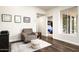 Cozy living room featuring a comfortable armchair, modern rug, and ample natural light from sliding glass doors at 12820 N 83Rd Pl, Scottsdale, AZ 85260