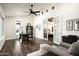 Open-concept living room showcasing a modern desk, wood floors, and French doors leading to the primary bedroom at 12820 N 83Rd Pl, Scottsdale, AZ 85260