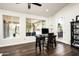 Bright living room boasts a modern desk, laminate wood floors, neutral paint, and natural light from large windows at 12820 N 83Rd Pl, Scottsdale, AZ 85260