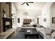 Open concept living room with vaulted ceilings, fireplace, and views into the kitchen at 12820 N 83Rd Pl, Scottsdale, AZ 85260