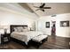 Serene bedroom with a dark accent wall, a ceiling fan, and an organized walk-in closet at 12820 N 83Rd Pl, Scottsdale, AZ 85260
