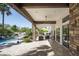 Inviting outdoor living space featuring stone columns, brick pavers, and a view of the sparkling pool at 12820 N 83Rd Pl, Scottsdale, AZ 85260