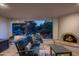 Cozy covered patio with a fireplace and beautiful view of the backyard at dusk at 12820 N 83Rd Pl, Scottsdale, AZ 85260