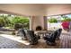 Outdoor patio area with fireplace and comfortable seating overlooking landscaped yard at 12820 N 83Rd Pl, Scottsdale, AZ 85260