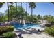 Resort-style pool with a waterfall feature, lush landscaping, and ample seating areas for outdoor entertaining at 12820 N 83Rd Pl, Scottsdale, AZ 85260