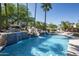 Inviting backyard pool with a rock waterfall feature and mature landscaping at 12820 N 83Rd Pl, Scottsdale, AZ 85260