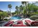 Serene pool area with rock waterfall, lounge chairs, and lush landscaping, perfect for outdoor relaxation and enjoyment at 12820 N 83Rd Pl, Scottsdale, AZ 85260