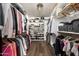Organized walk-in closet with custom shelving, hanging rods, and dedicated storage for clothes, shoes, and accessories at 12820 N 83Rd Pl, Scottsdale, AZ 85260