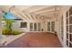 Outdoor patio with brick pavers, a white wood beam ceiling and string lights at 13007 N 1St St, Phoenix, AZ 85022