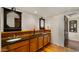 Bathroom featuring dual sinks, custom cabinetry and a charming rustic design at 13007 N 1St St, Phoenix, AZ 85022