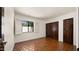 Bedroom with dark stained doors and shutters over the window at 13007 N 1St St, Phoenix, AZ 85022
